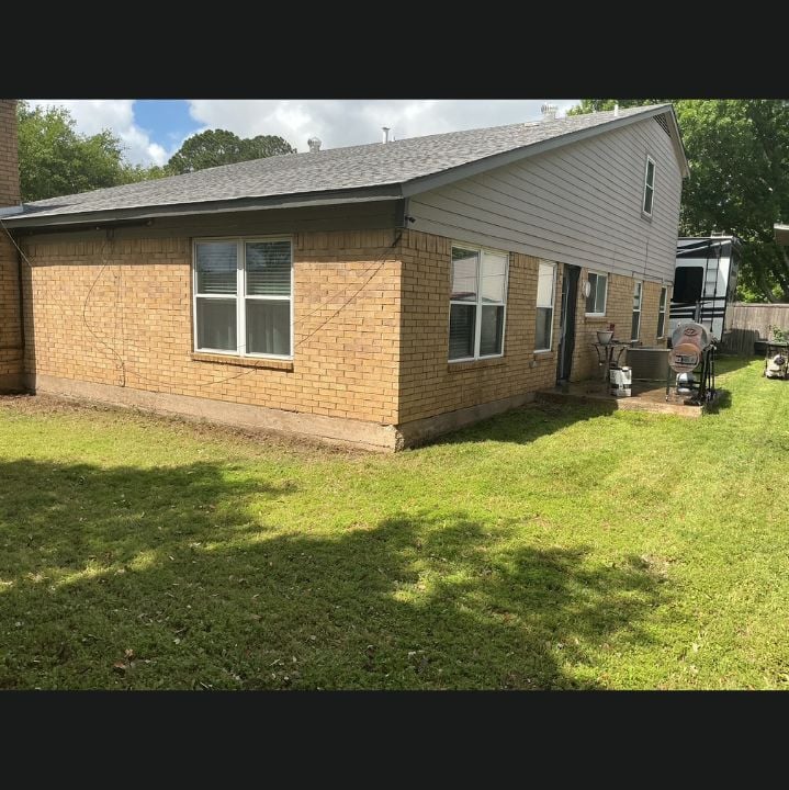 Clean tan brick exterior of the same Arlington, Texas home after house washing by Hydro Hustle