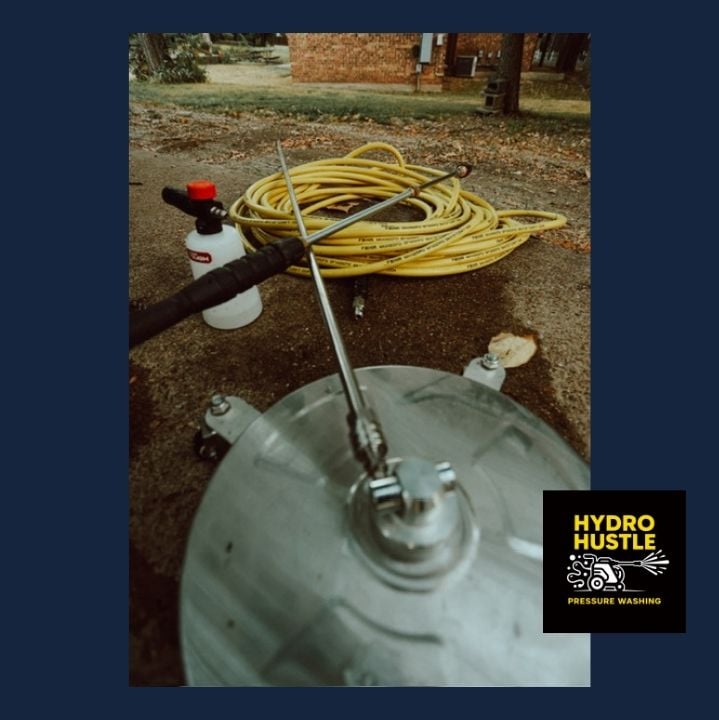 Rotary surface cleaner, hose, wand, and foam cannon staged on a driveway at an Arlington, Texas job site