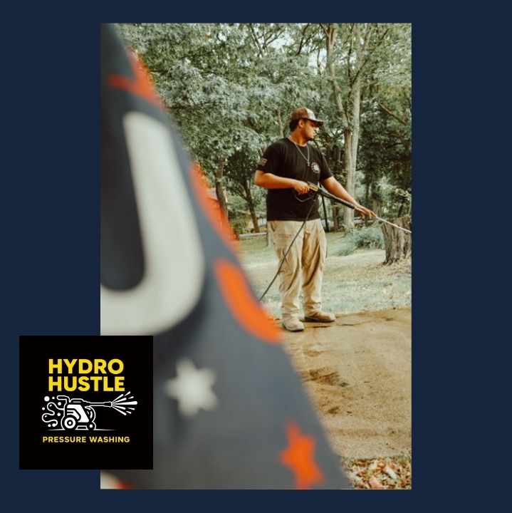 Jeremiah Adams of Hydro Hustle pressure washing a driveway at an Arlington, Texas home